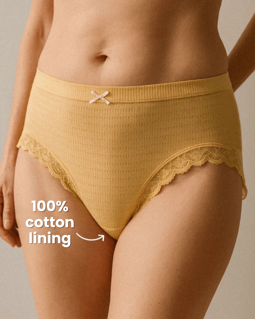 Mustard yellow underwear with lace trim and 100% cotton lining text.